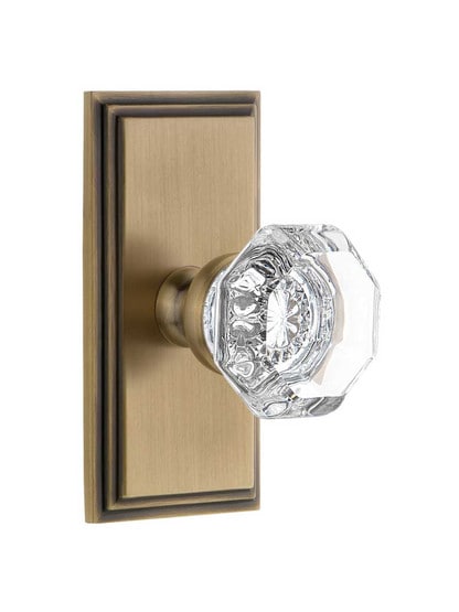 Grandeur Carre Rosette Door Set with Chambord Crystal-Glass Knobs in Antique Brass.